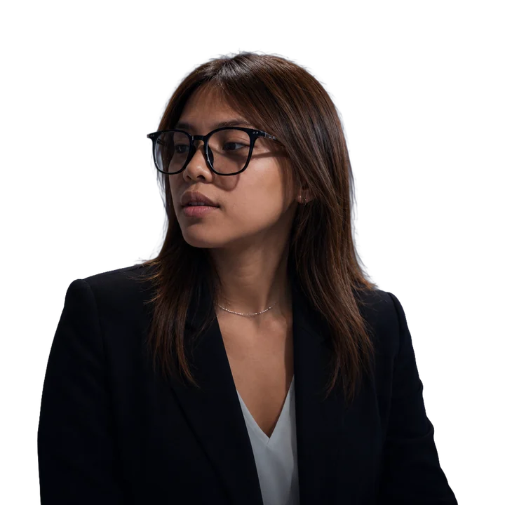 Portrait of Chel Gadores wearing black glasses and a dark blazer